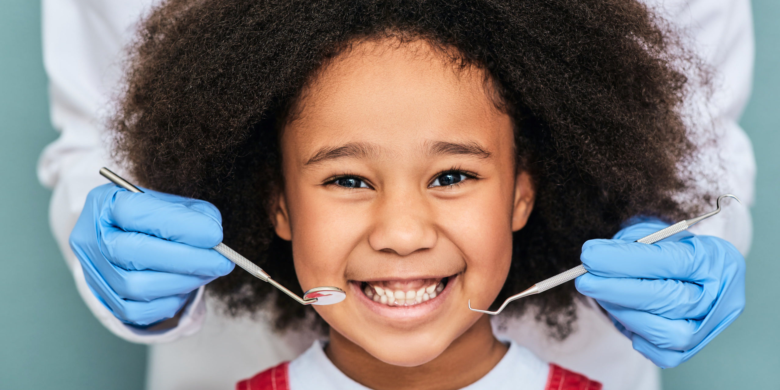 African,American,Little,Girl,With,A,Toothy,Smile,During,An