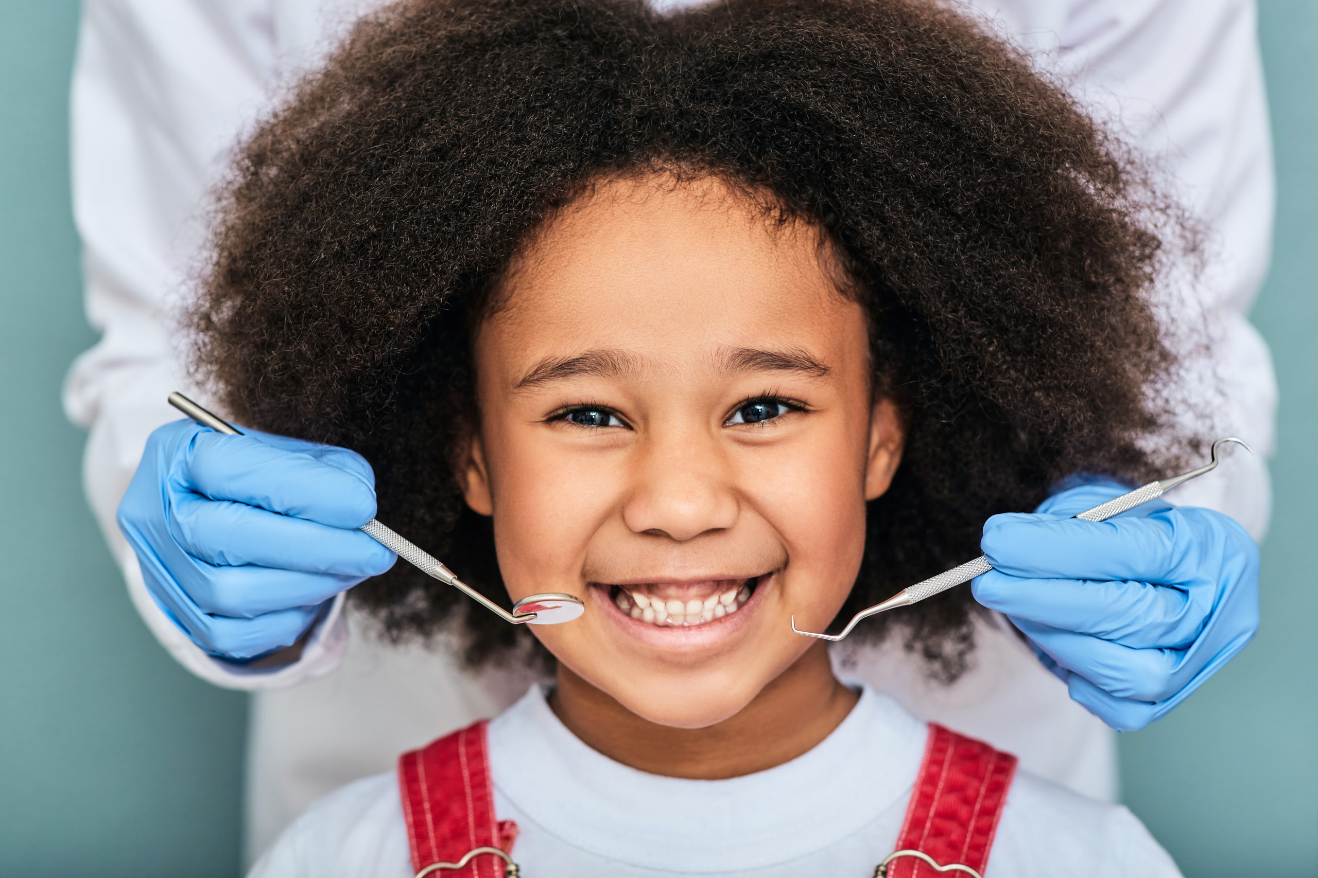 African,American,Little,Girl,With,A,Toothy,Smile,During,An